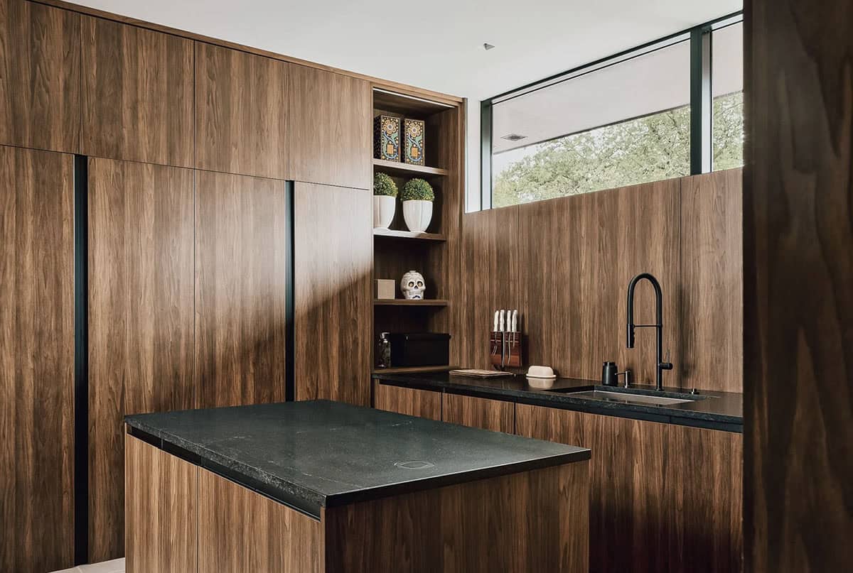 Walnut butler's pantry with dark stone countertop and skull decor