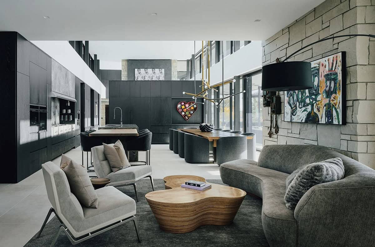 Open living and dining space with stone accent wall