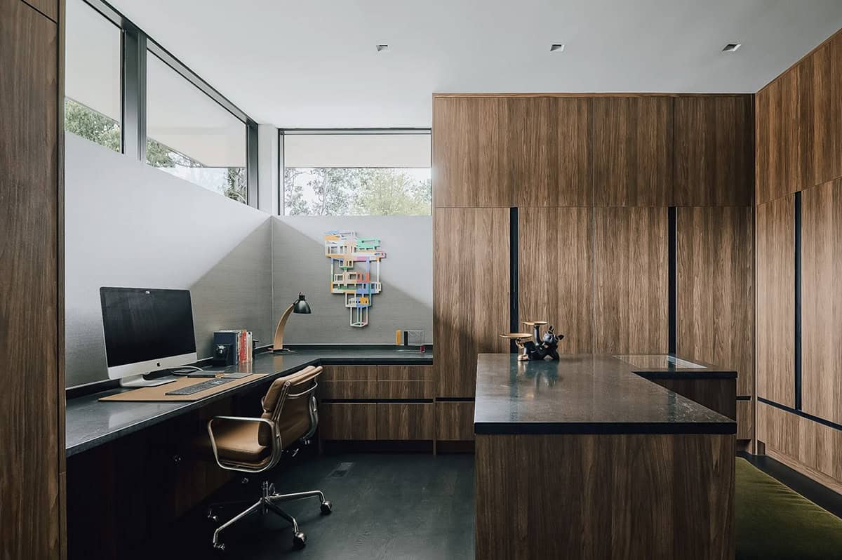 Home office nook with walnut cabinetry and colorful wall sculpture