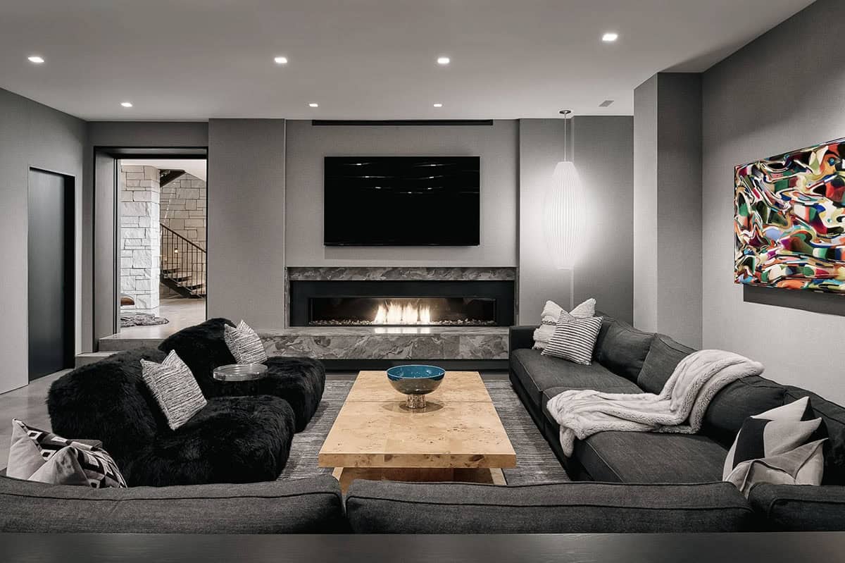 Lower level lounge with fireplace and colorful abstract artwork