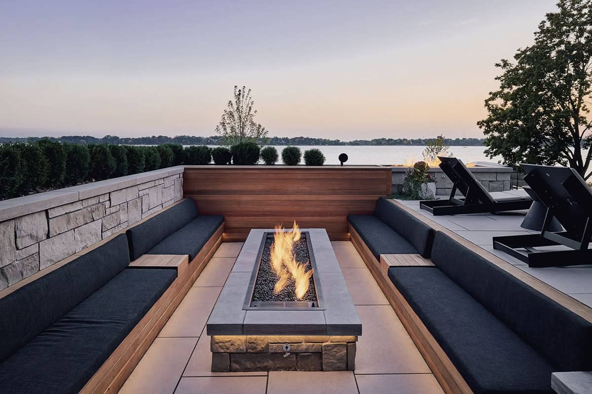 Sunken lakeside fire pit lounge with built in bench seating