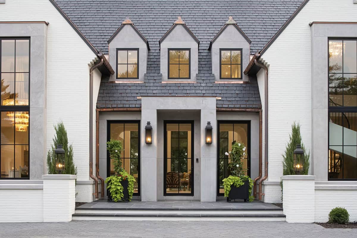 Front entry with dormer windows and copper-topped gable accents