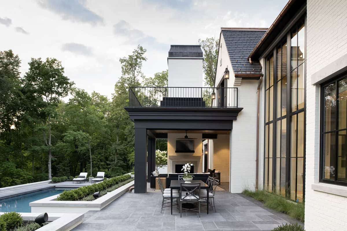 Covered patio with rooftop balcony overlooking the backyard pool