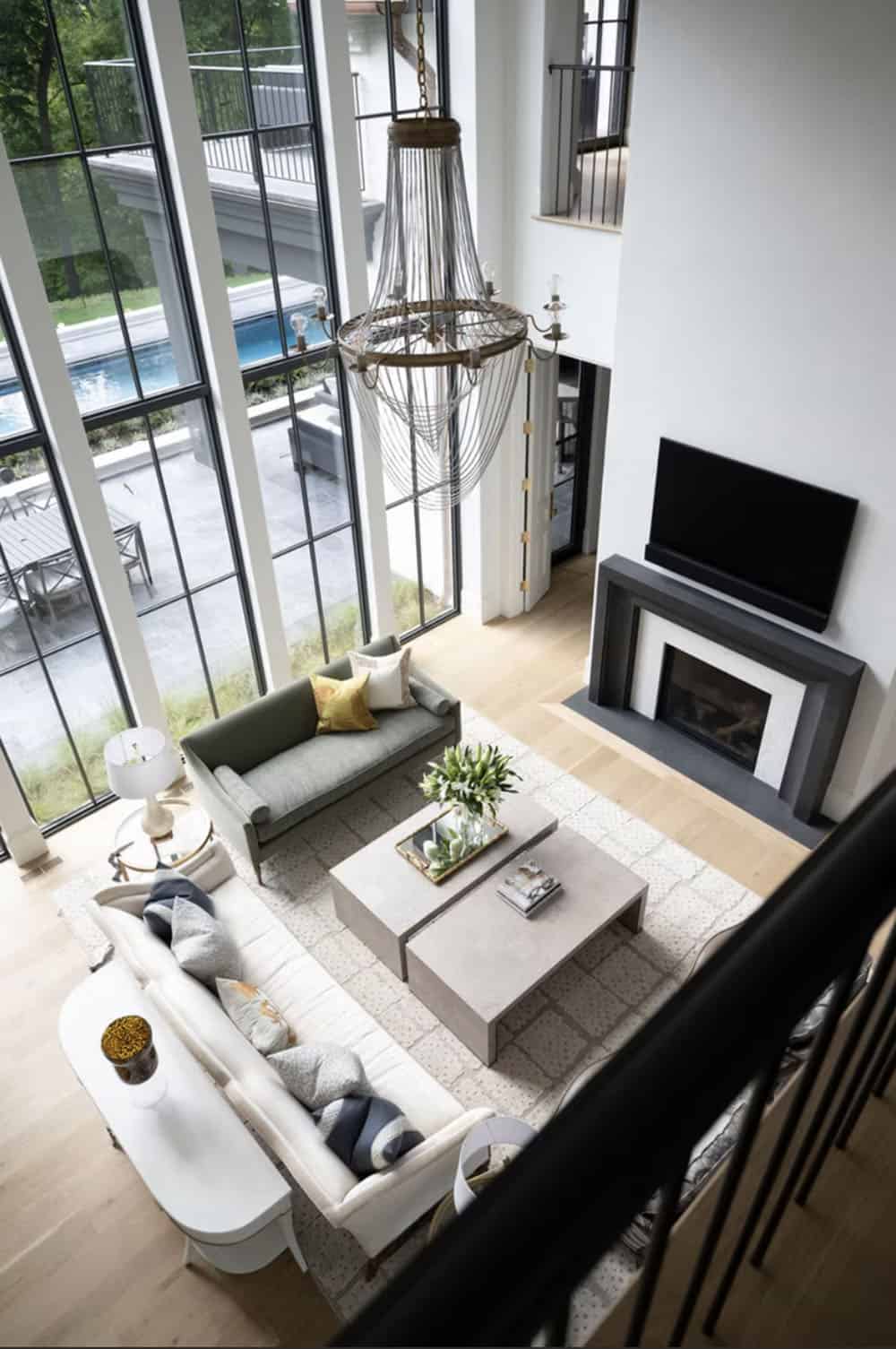 Overhead view of great room with chandelier and glass wall