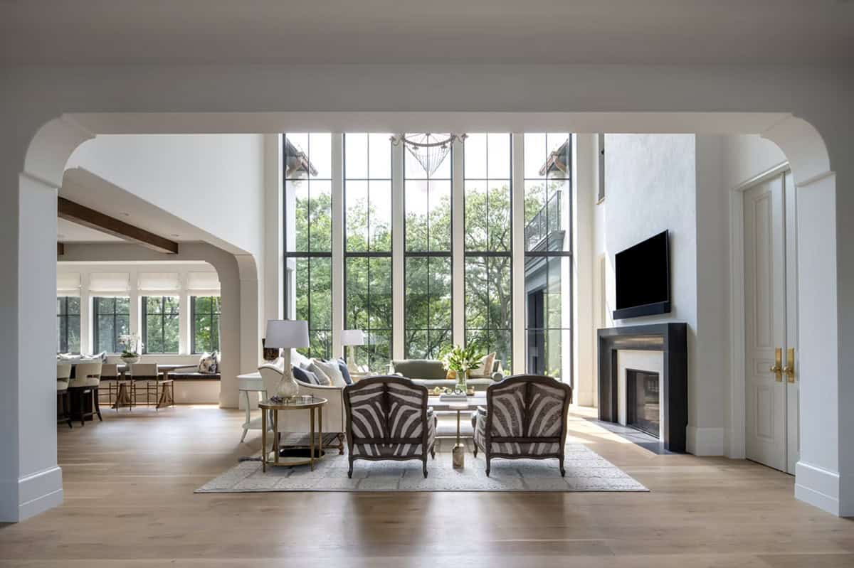 Arched entry framing two-story great room with floor-to-ceiling windows