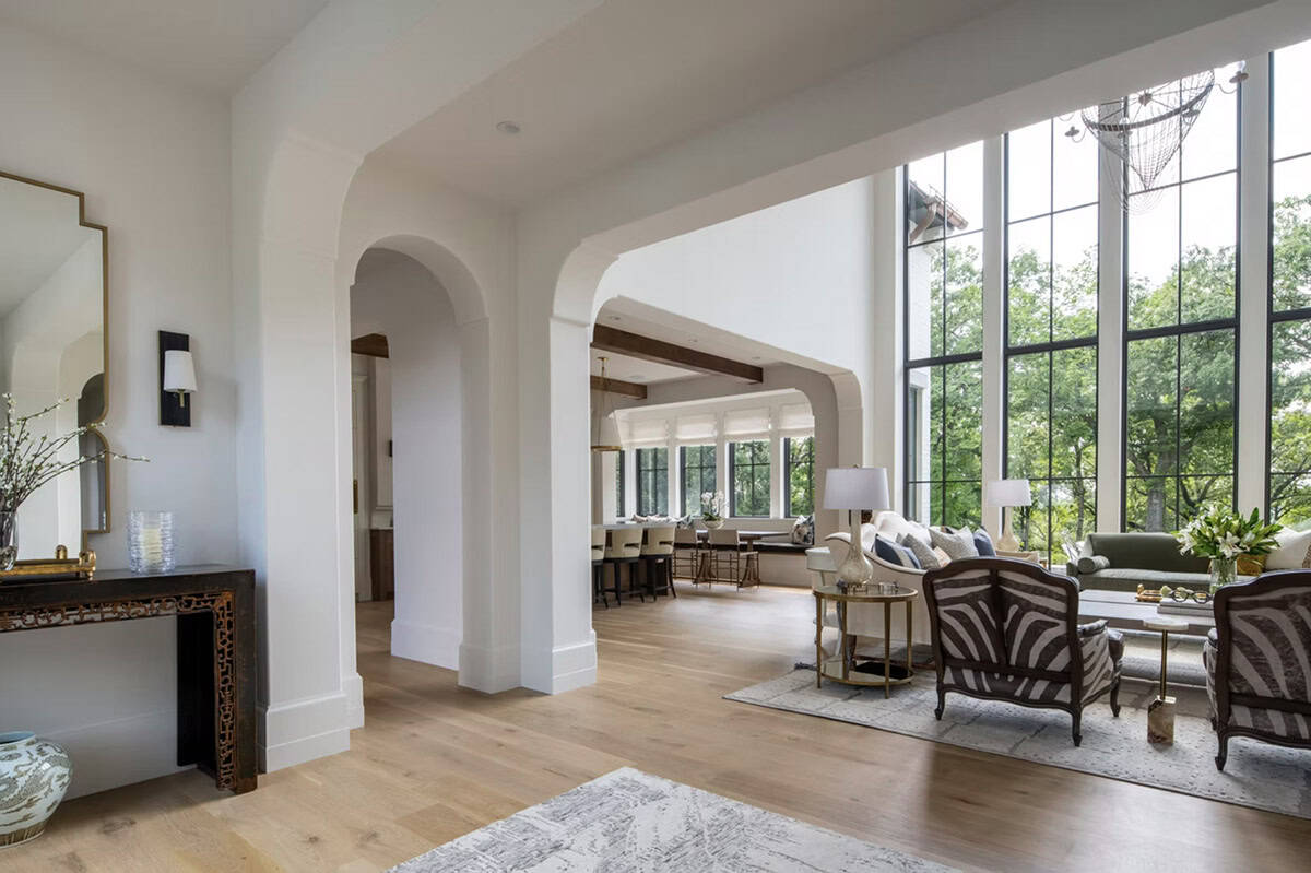 Console table framing archways into kitchen and great room