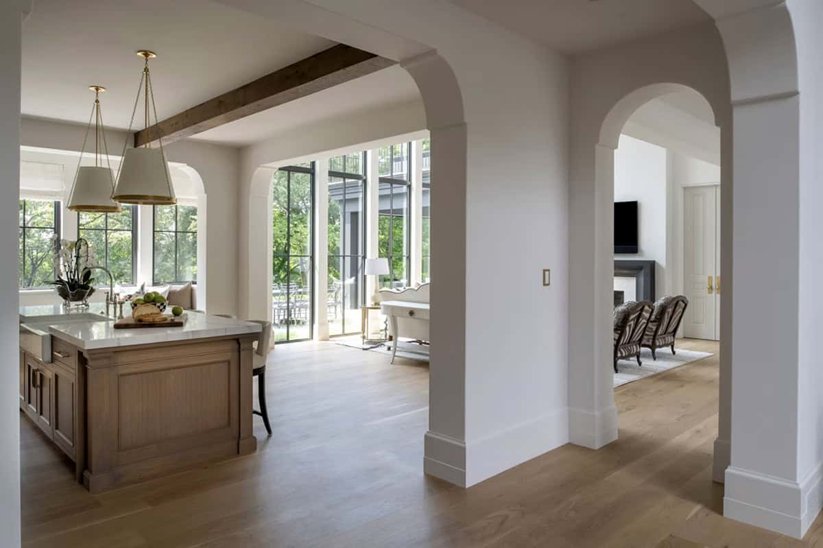 Kitchen island with wood beam ceiling opening to great room