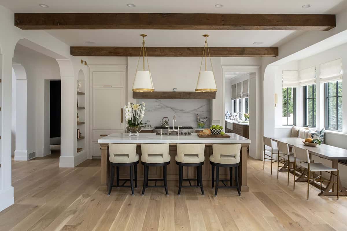 Kitchen island with marble backsplash and window banquette seating