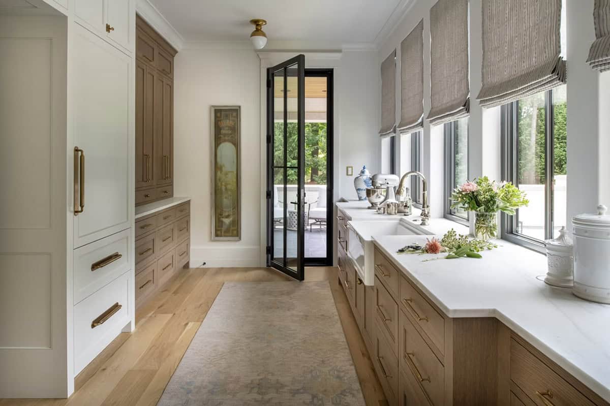Butler's pantry with farmhouse sink and reeded roman shade windows