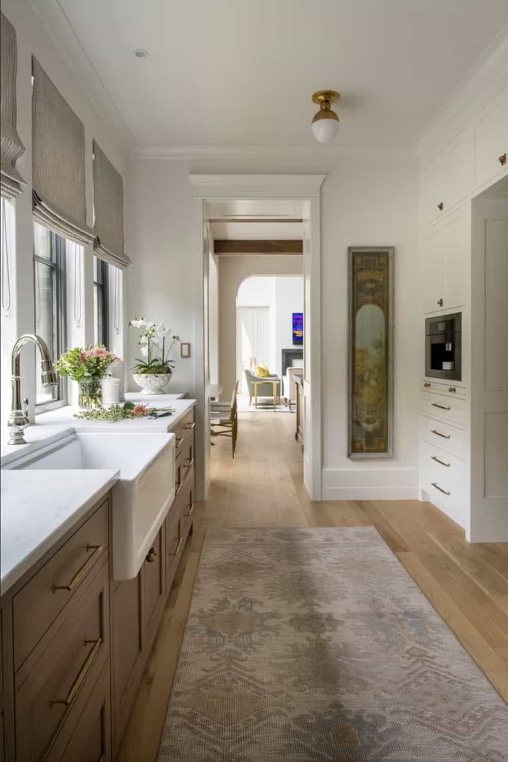 View down butler's pantry hallway toward great room fireplace