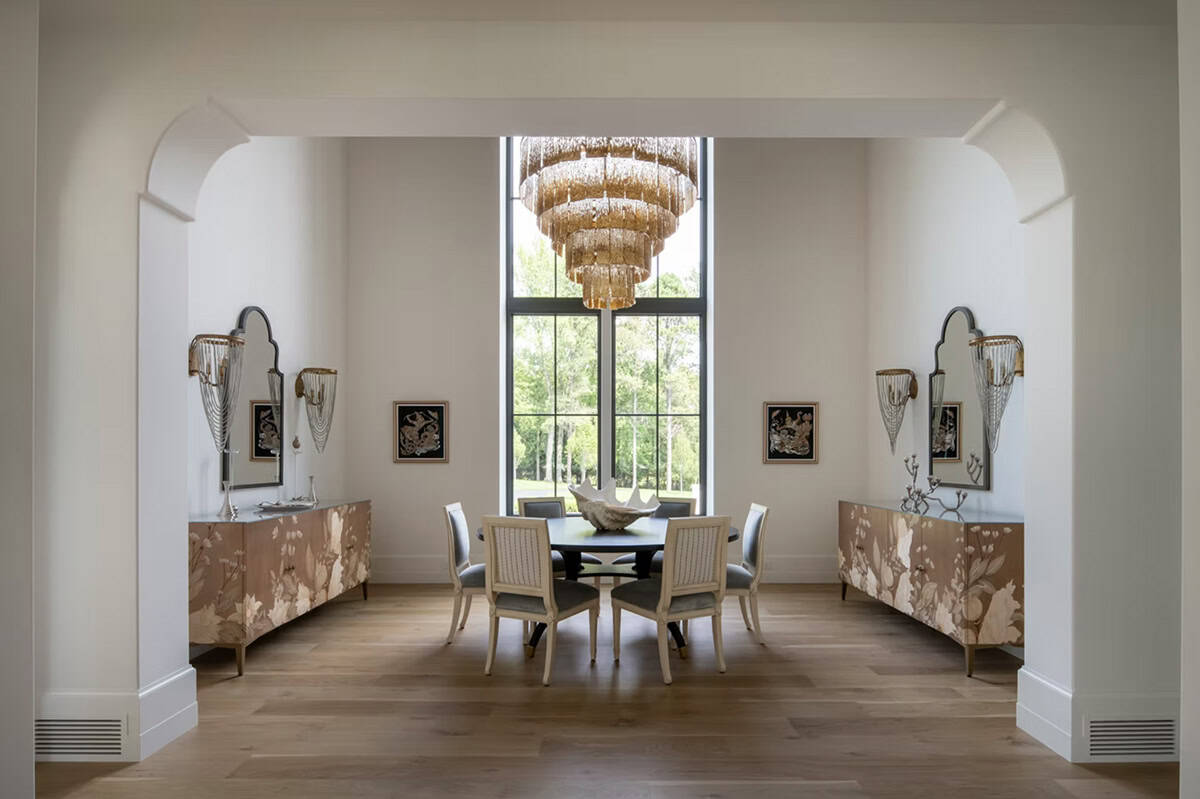 Formal dining room framed by matching sideboards and wall sconces