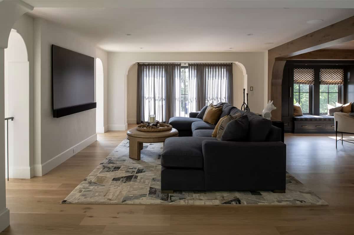 Family room with sectional sofa and arched window seat beyond