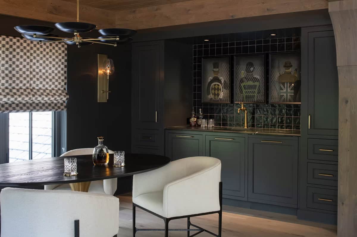 Dark bar area with gallery portraits and brass tap fixture