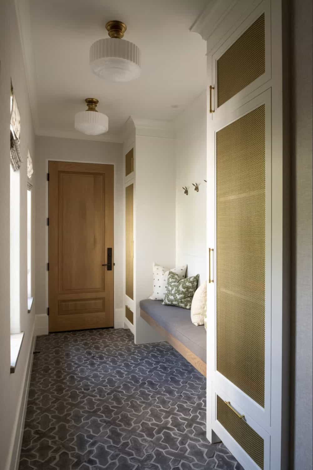 Mudroom bench with woven cabinet fronts and patterned tile floor