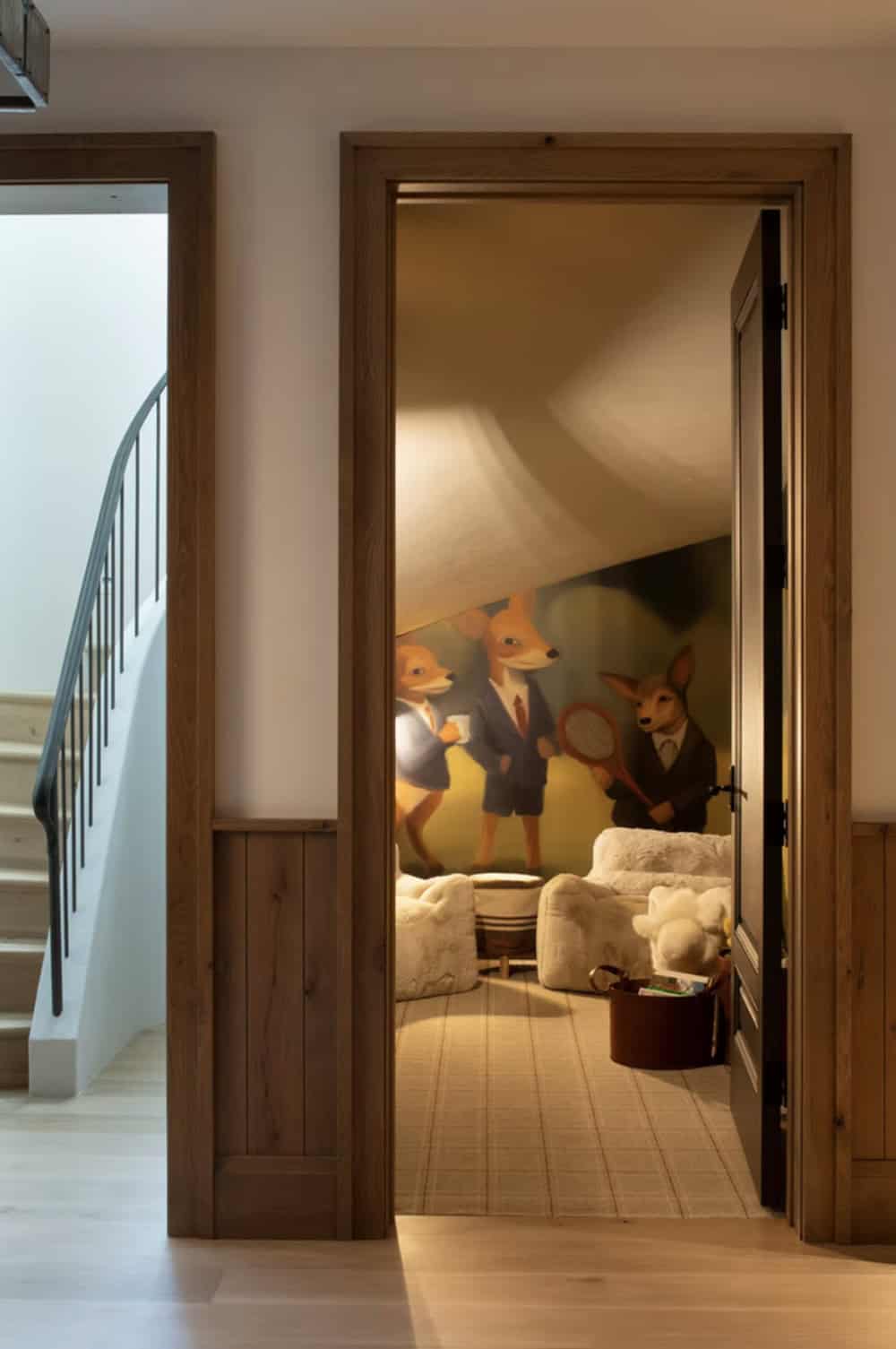 Playroom doorway with whimsical animal mural and plush seating