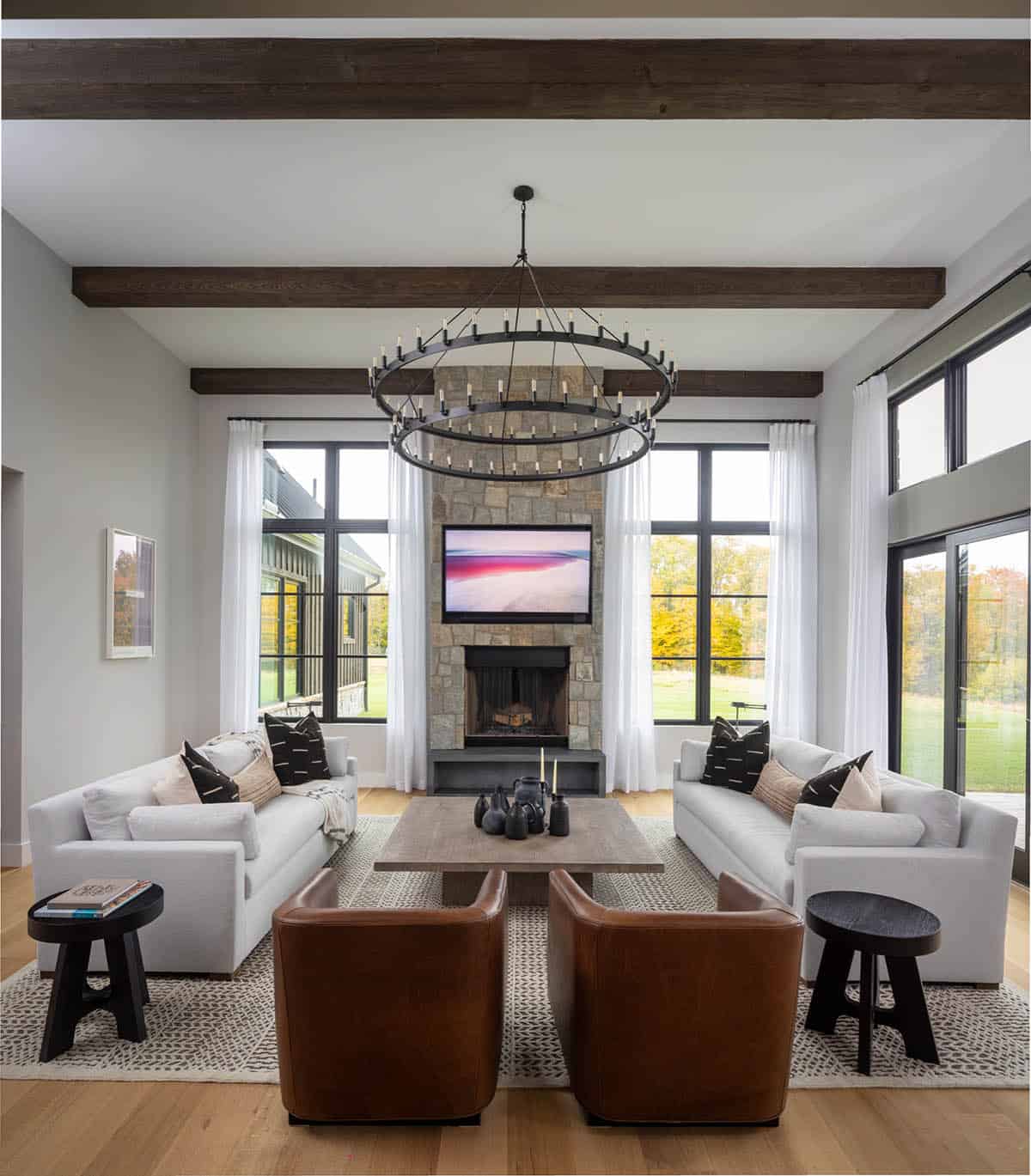Living room with vaulted ceiling and wraparound ring chandelier