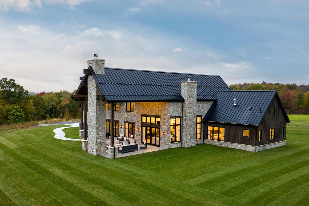 Aerial exterior view showing covered patio and stone chimney