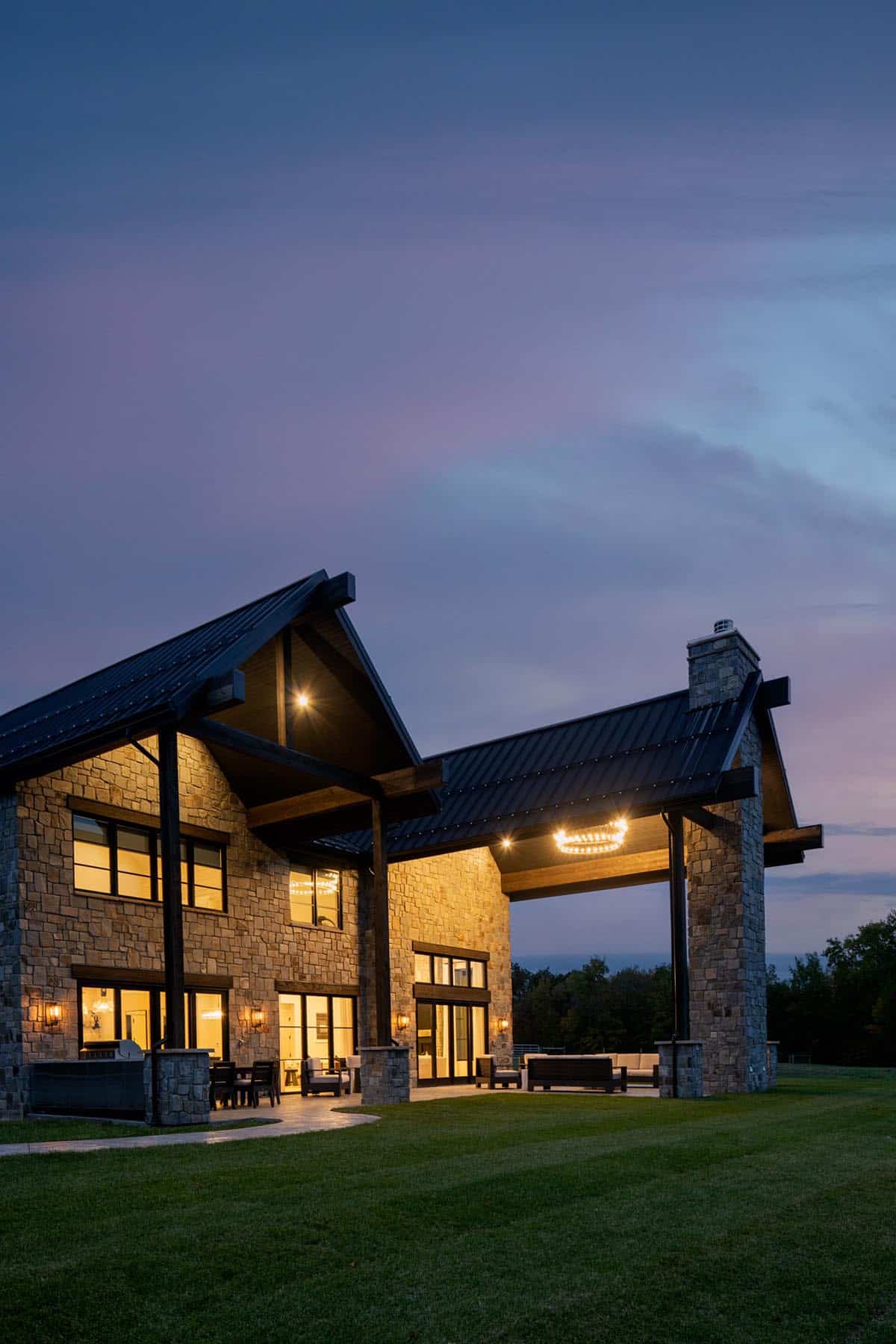 Rear exterior at dusk with covered outdoor living space