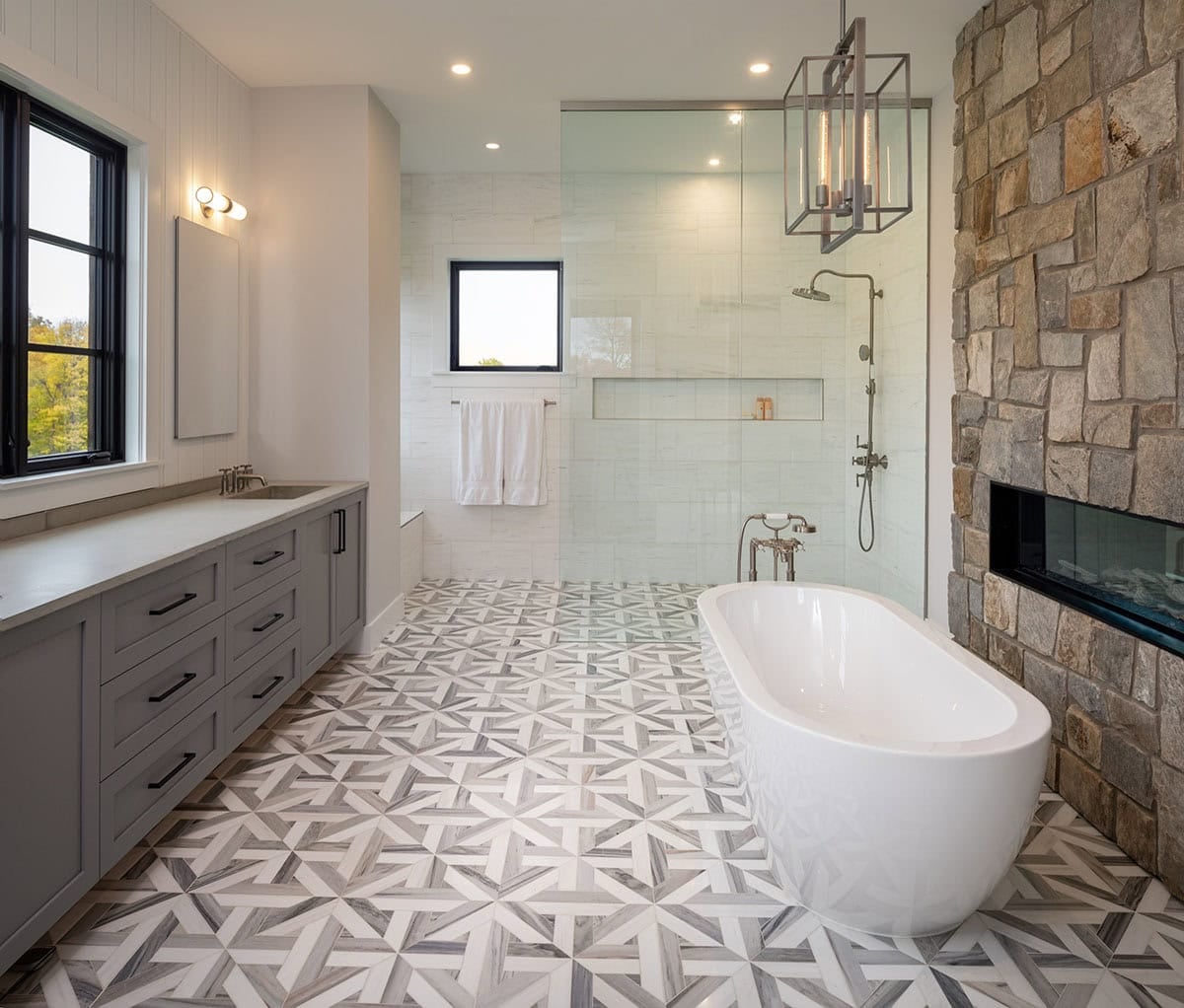 Primary bathroom with geometric marble floor tile and walk-in shower