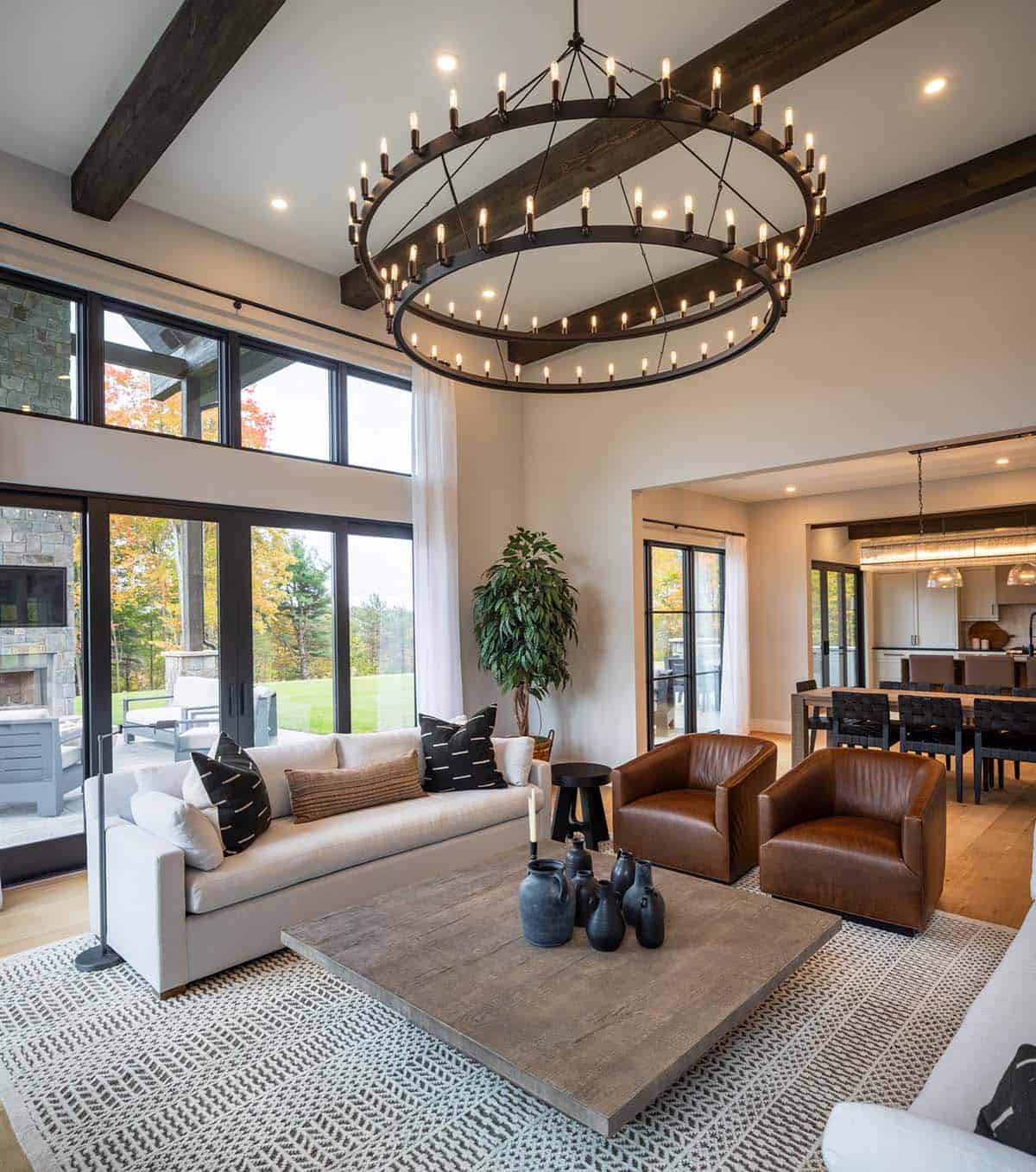 Living room with tiered wagon-wheel chandelier and leather chairs