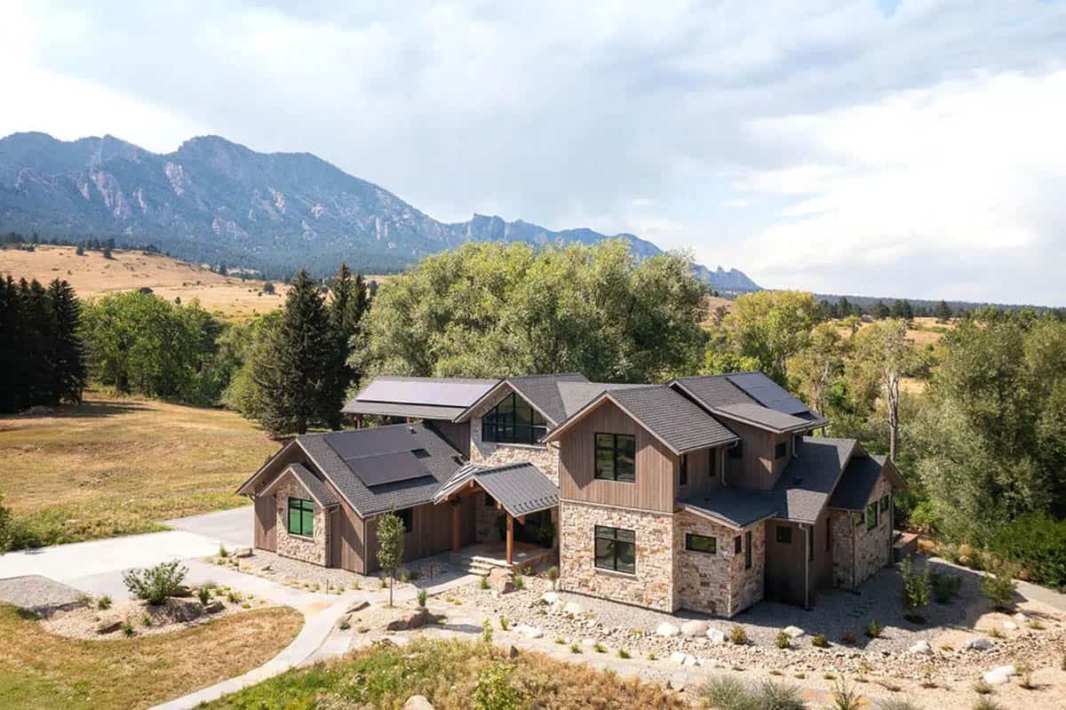 Aerial view of modern mountain home with Flatirons rising behind