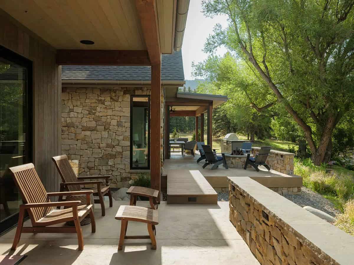 Covered patio leading to outdoor grill and fire pit seating area