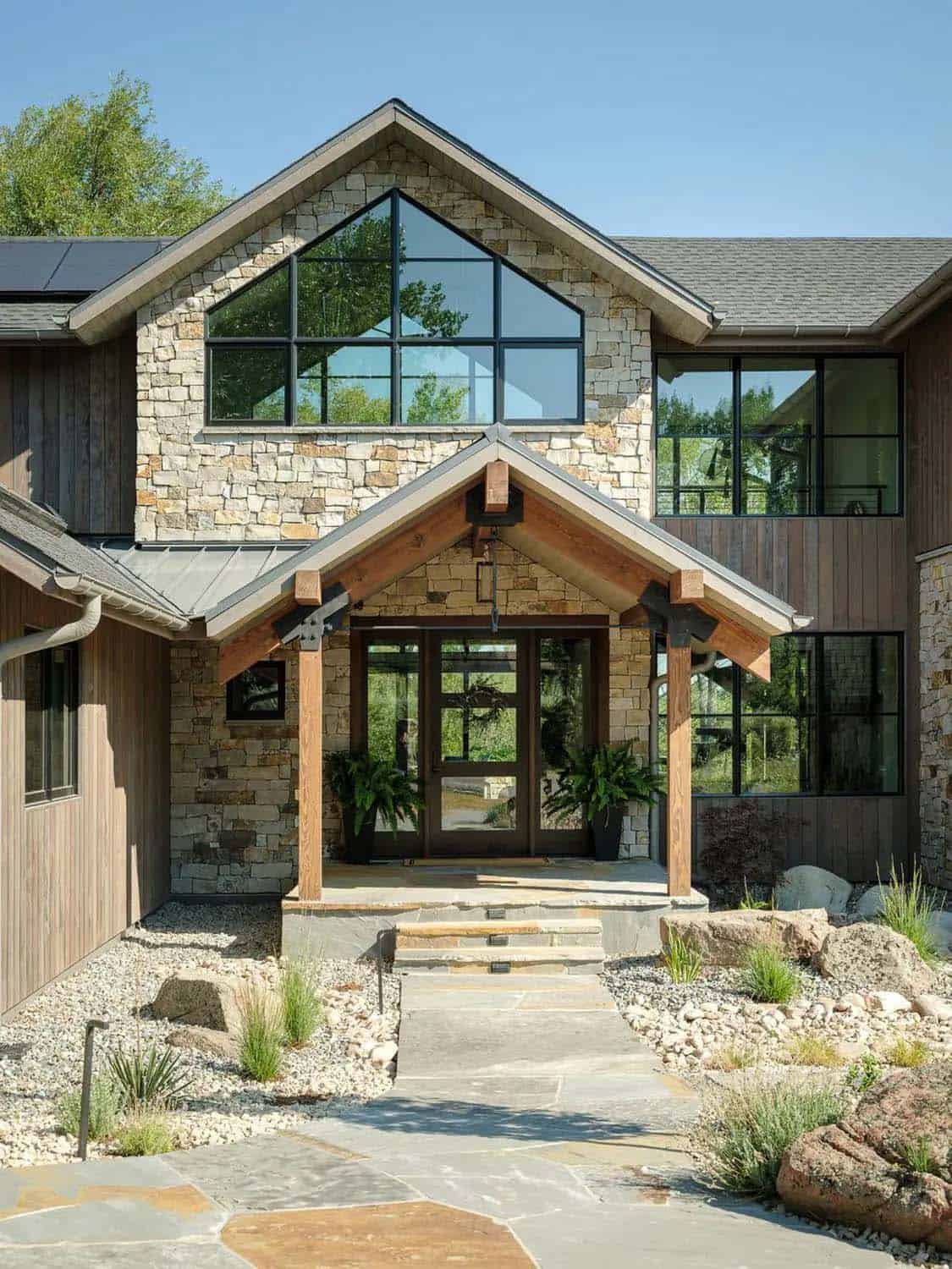 Timber-framed front entry with stone gable and steel bracket details