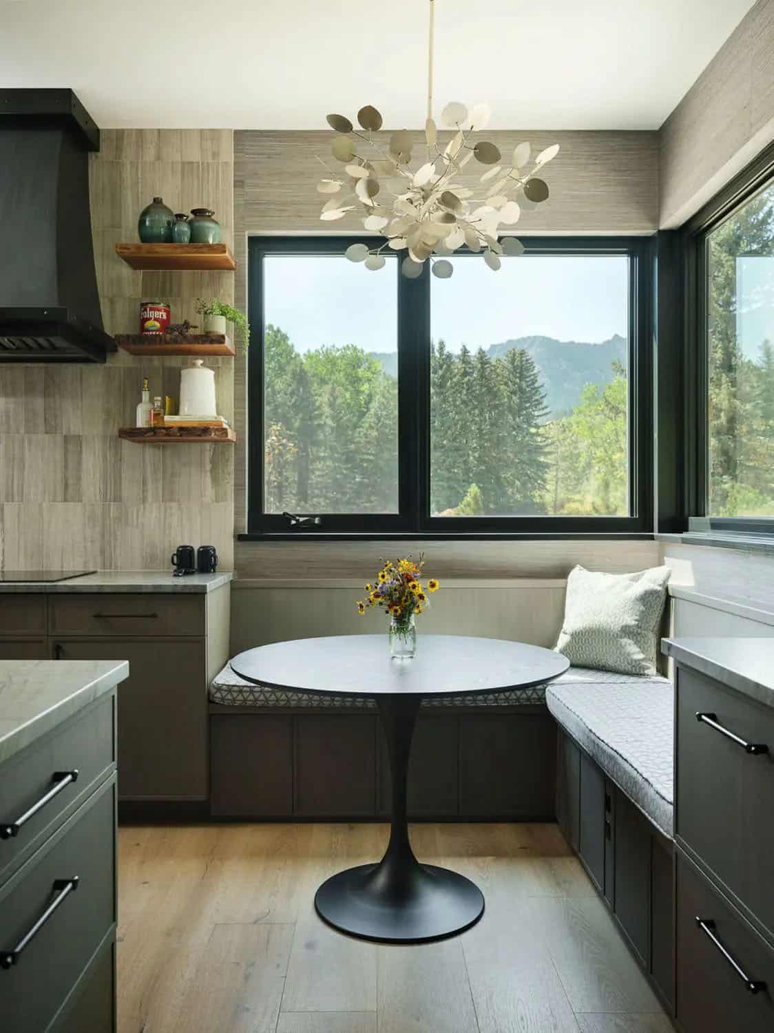 Kitchen breakfast nook with round table, corner banquette, and mountain views