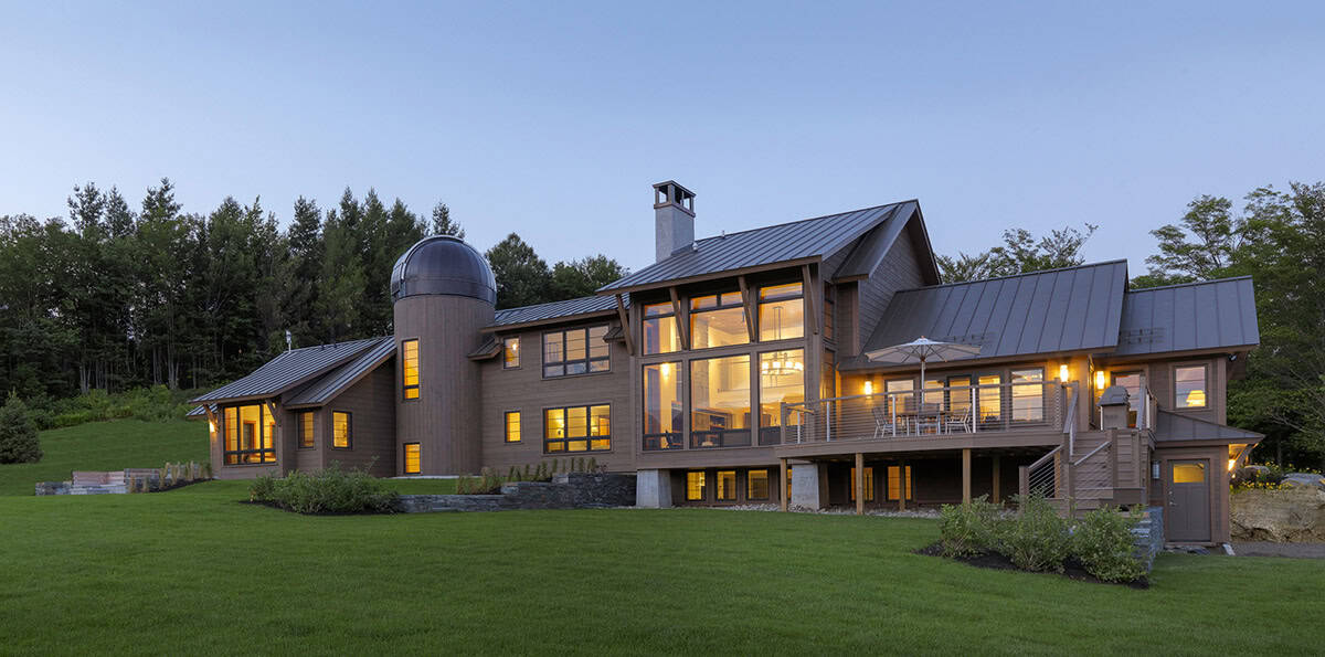 Twilight exterior showing timber frame gable and observatory