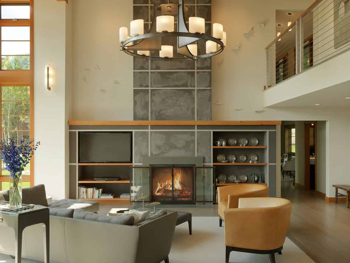Living room fireplace with paper airplane wall art and loft railing above