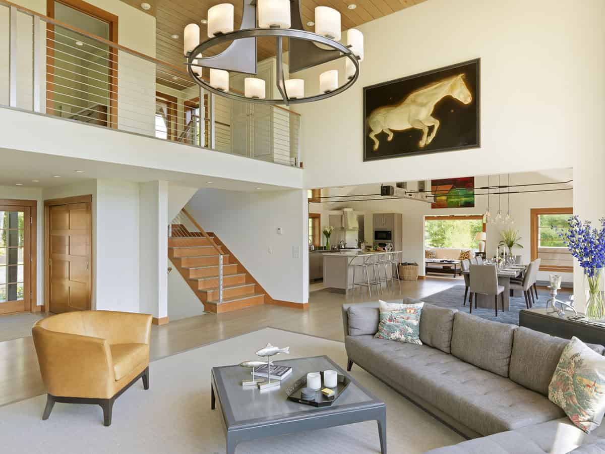 Open concept living room with leather chair and dining area beyond