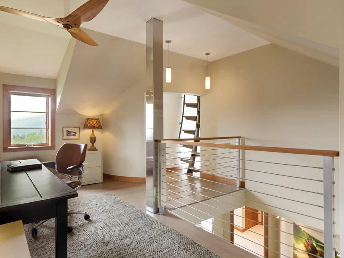 Loft office nook with desk, ceiling fan, and ladder to attic