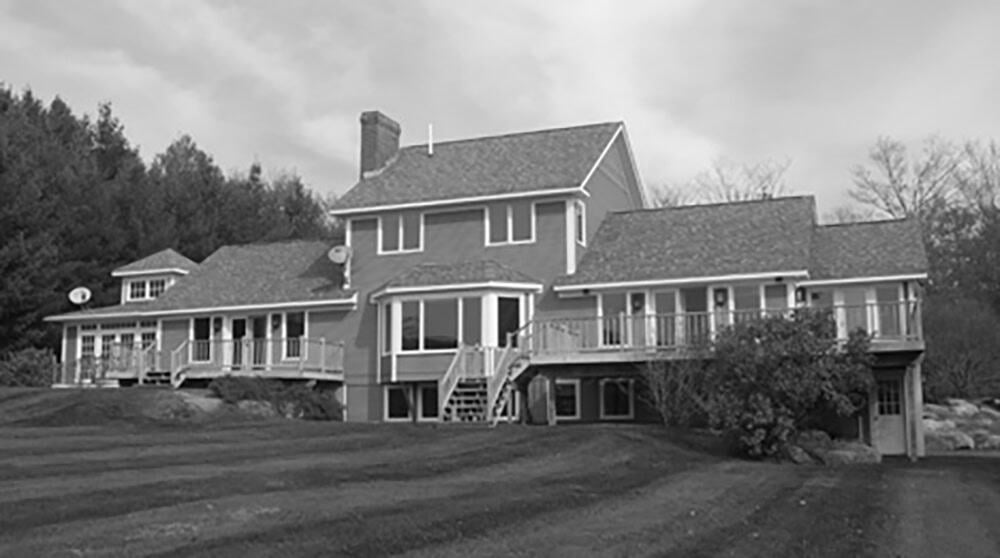 Black and white before photo of the original traditional gabled farmhouse