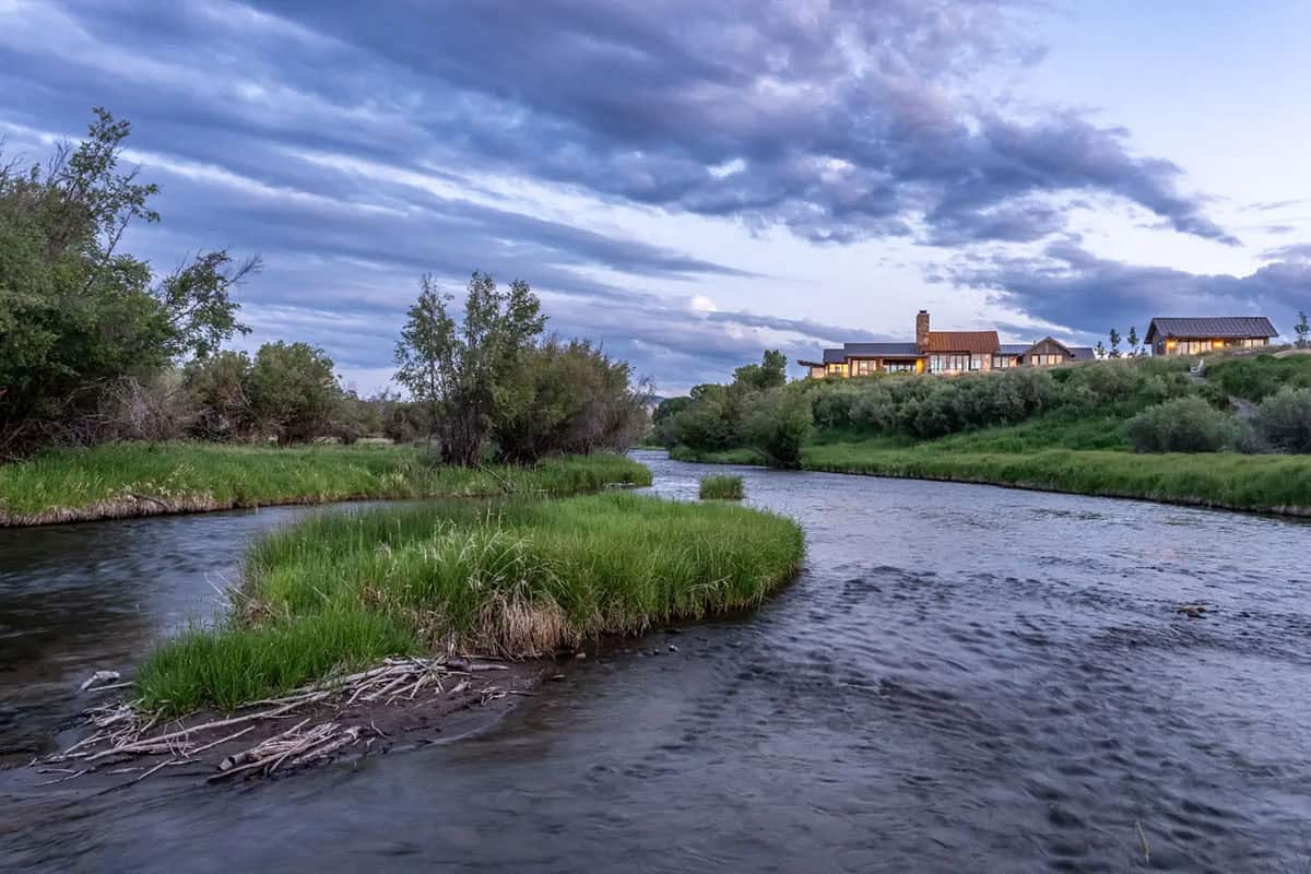 Home on a plot of land above a winding Montana stream
