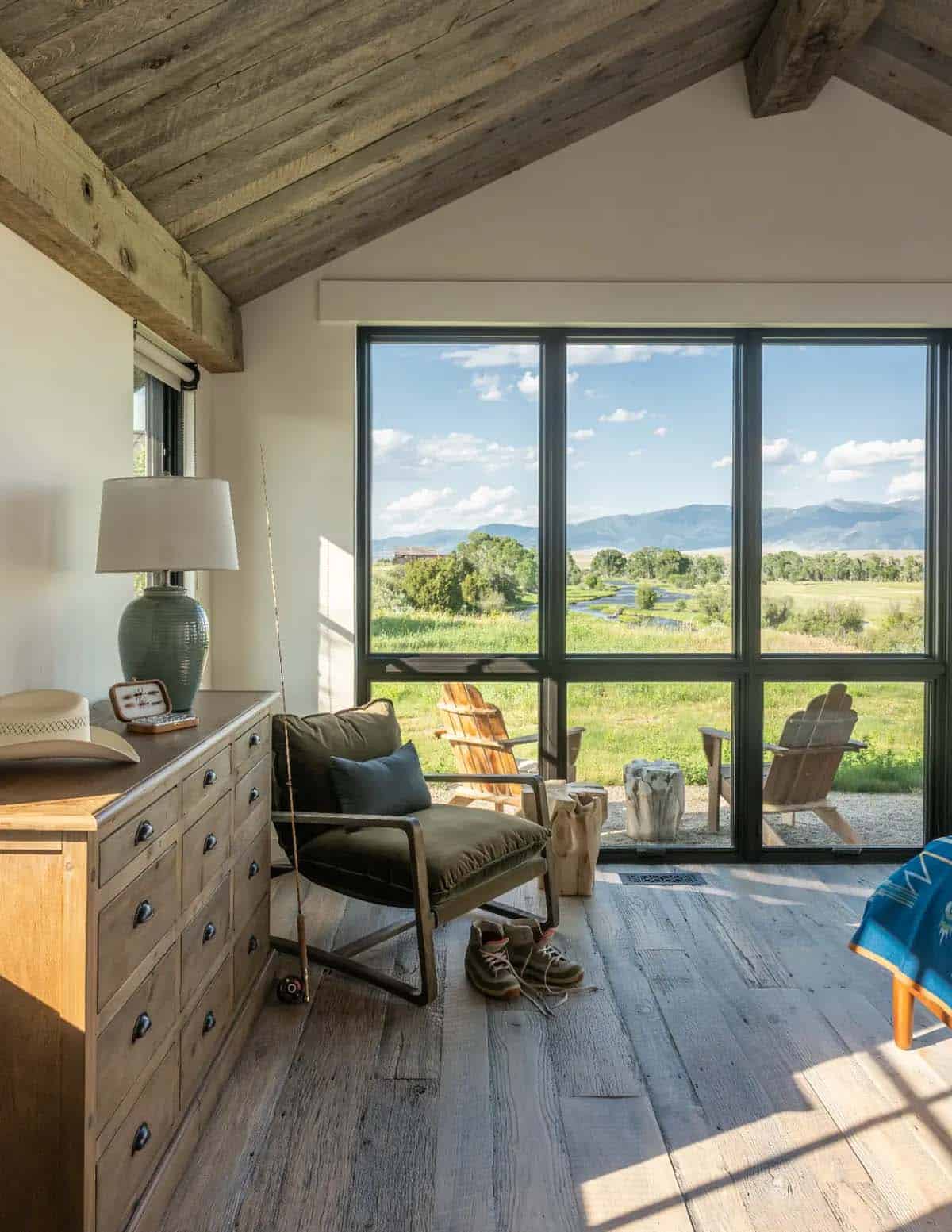 Bedroom with vaulted wood ceiling, fly rod and stream view