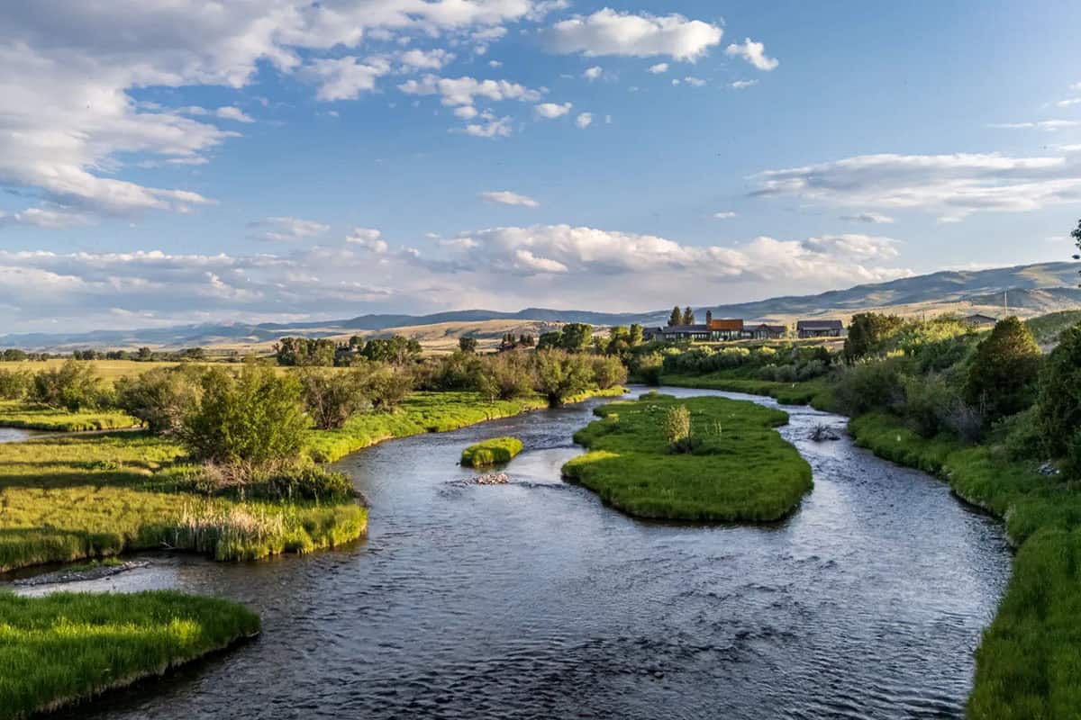 Winding spring-fed stream with the Montana home in the distance