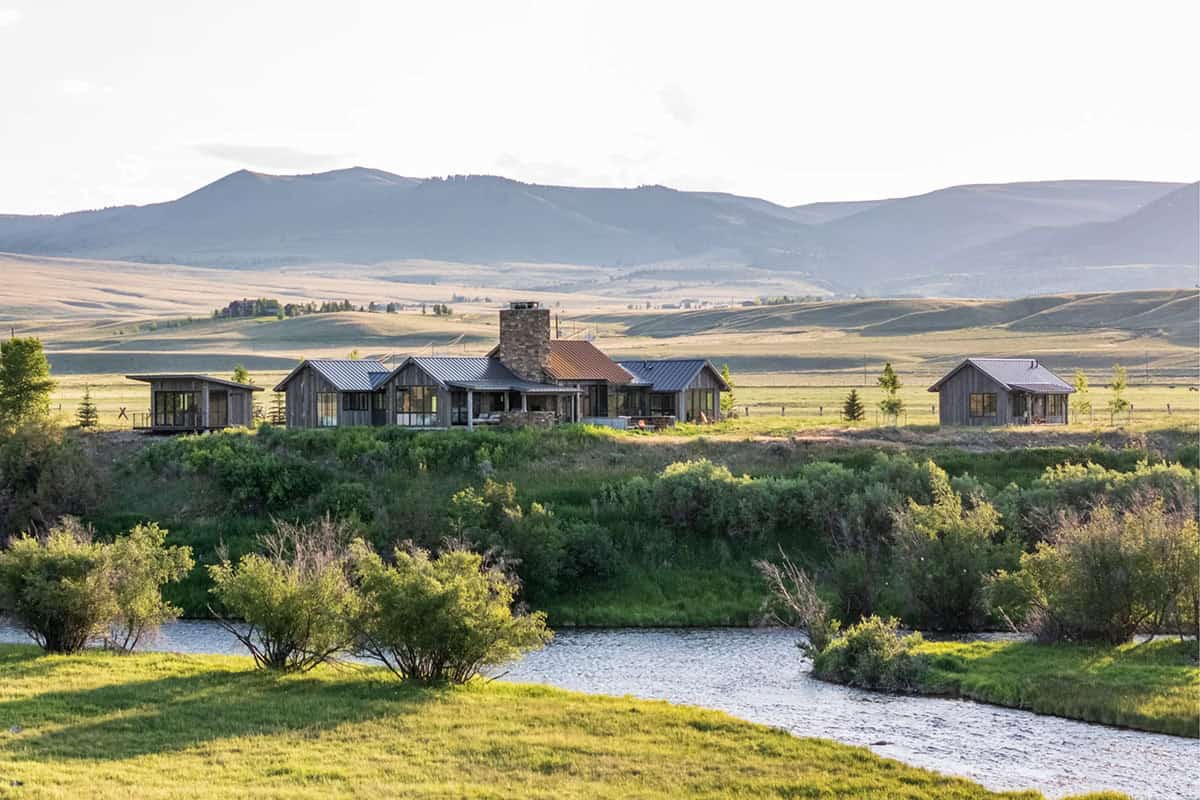 Montana home and cabins on a hillside above the stream