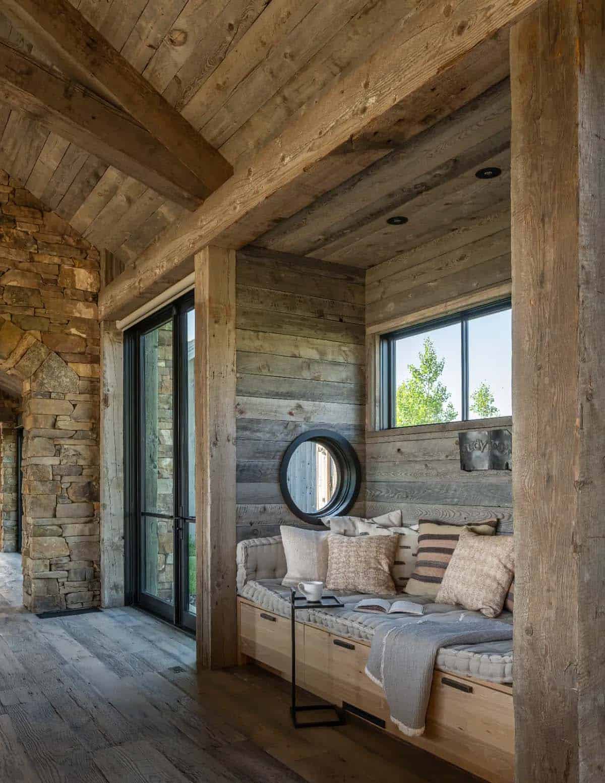 Reading nook with round window and reclaimed wood walls
