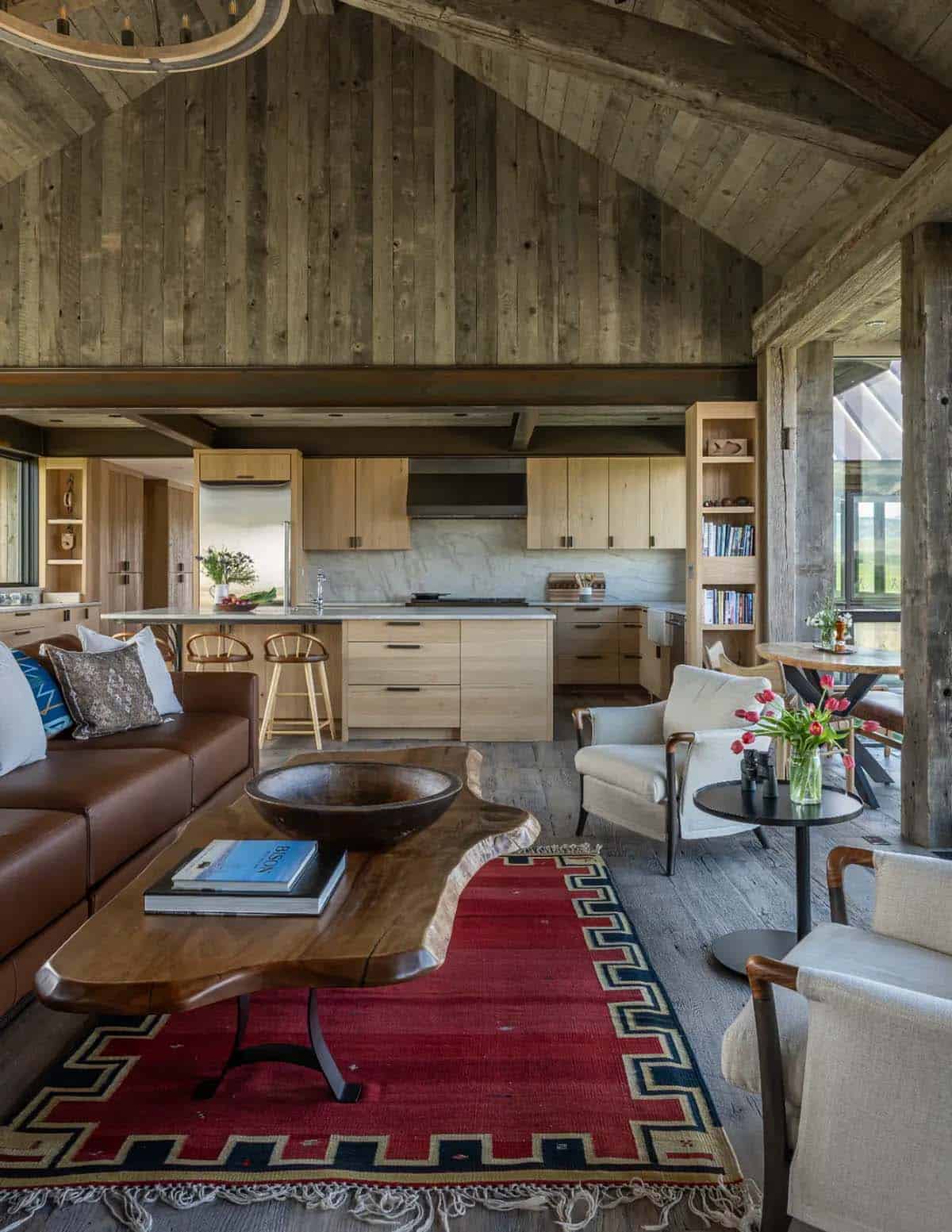 Open living room and kitchen with vaulted reclaimed wood ceiling