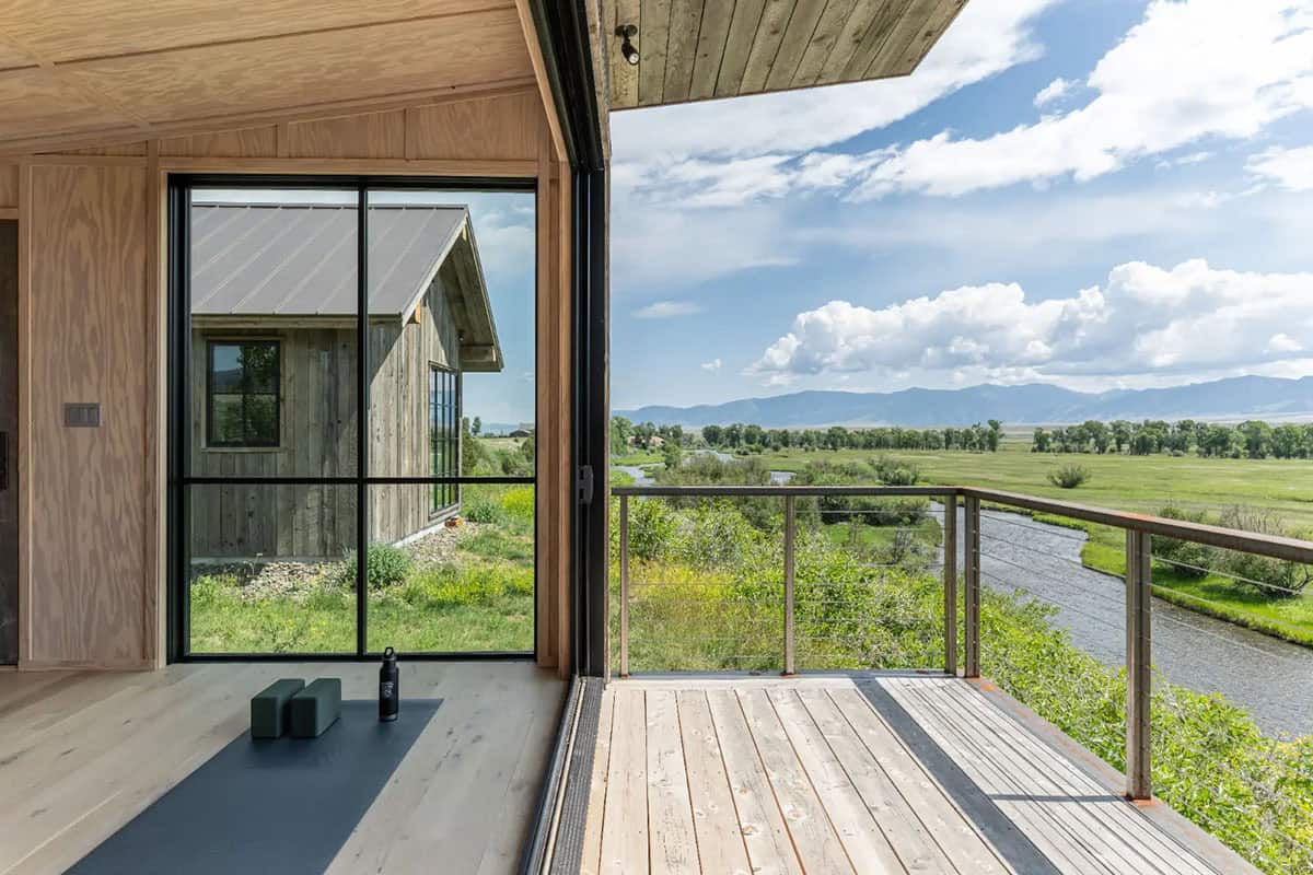 Studio deck with cable railing overlooking the stream and meadow