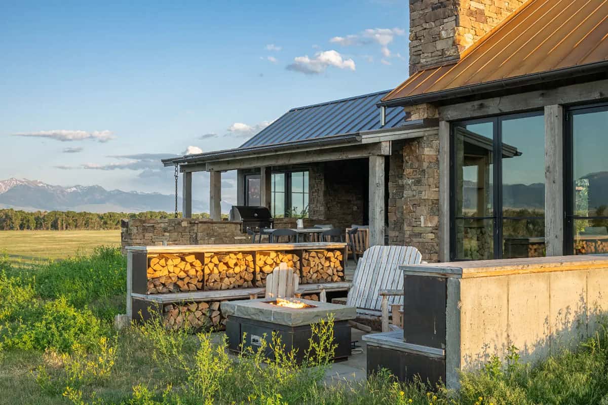 Fire pit and stacked firewood beside the covered patio