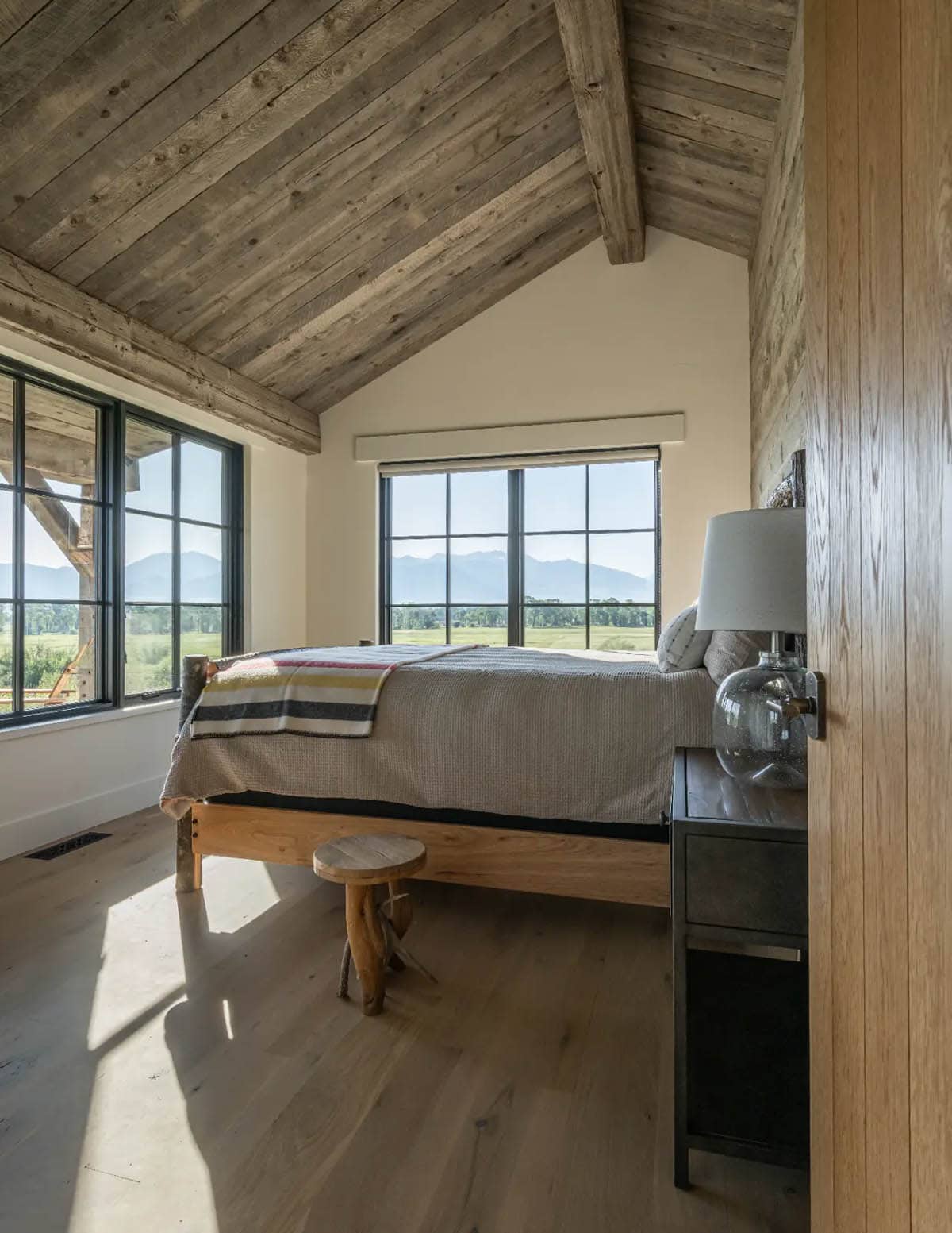 Guest bedroom with vaulted ceiling and mountain view windows