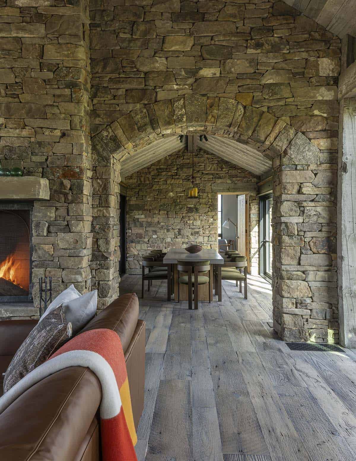 Stone archway leading from the fireplace living room to the dining area