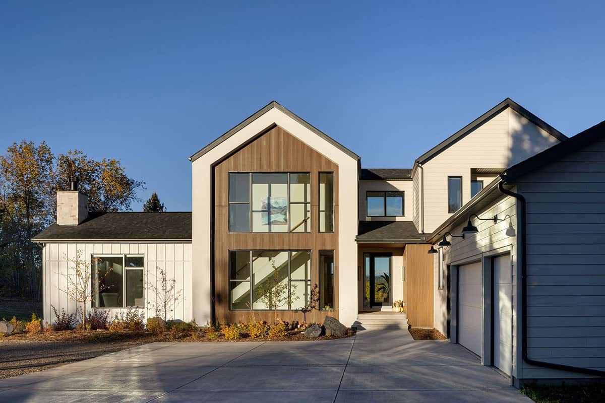 Modern farmhouse exterior with gabled wood accent and glass entry