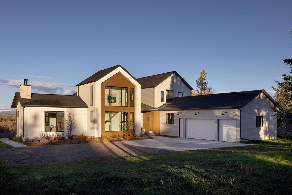 Modern Scandinavian home exterior with mixed gable rooflines and wood siding