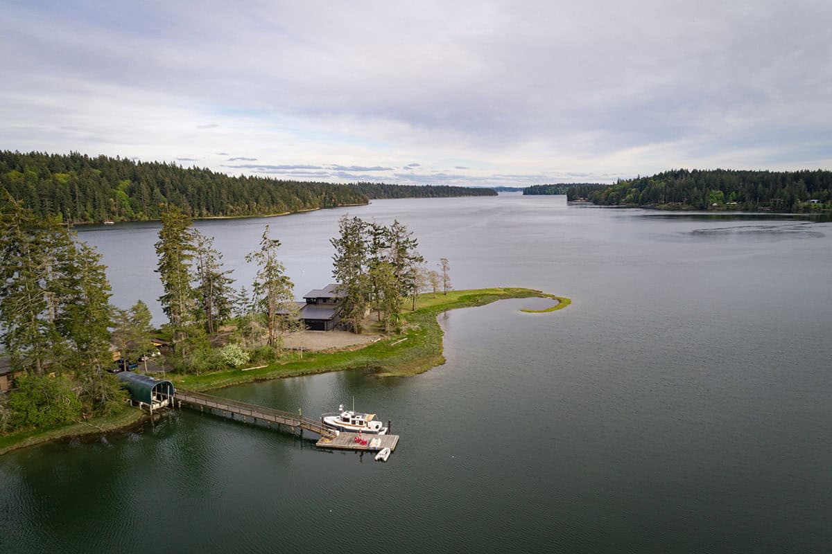 Aerial view of a waterfront home on a narrow peninsula