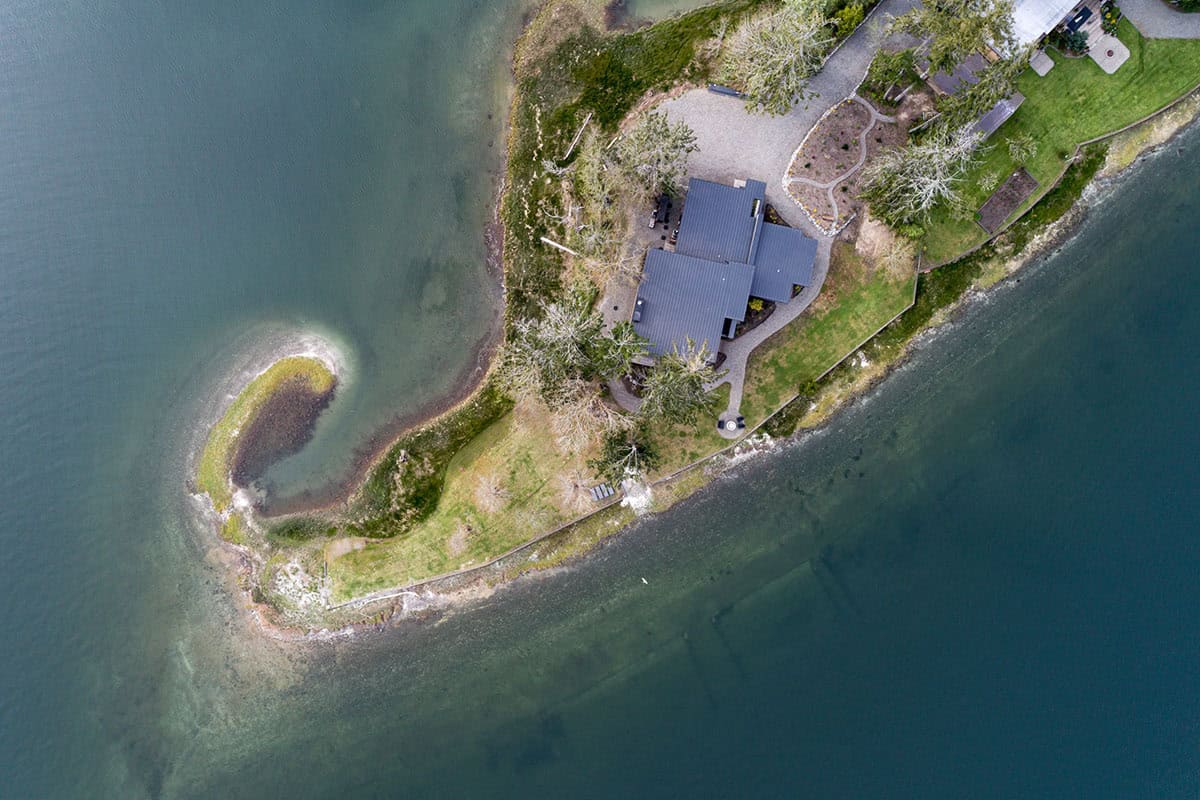 Overhead view of the roofline and shoreline landscaping surrounding the home