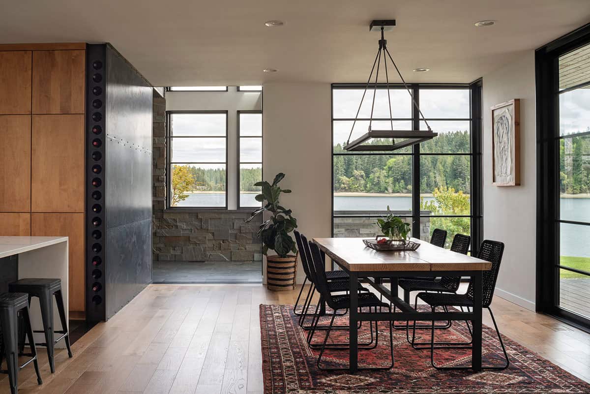 Dining area with a wine wall and floor to ceiling water views