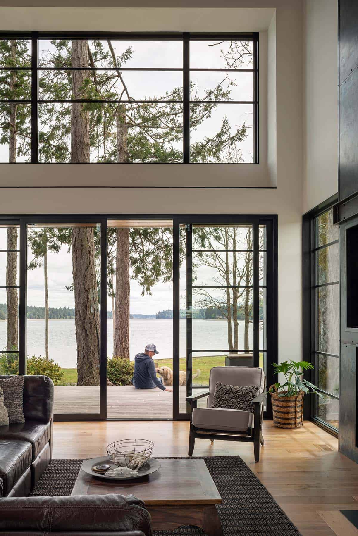 Living room sliding doors open to a deck overlooking the water