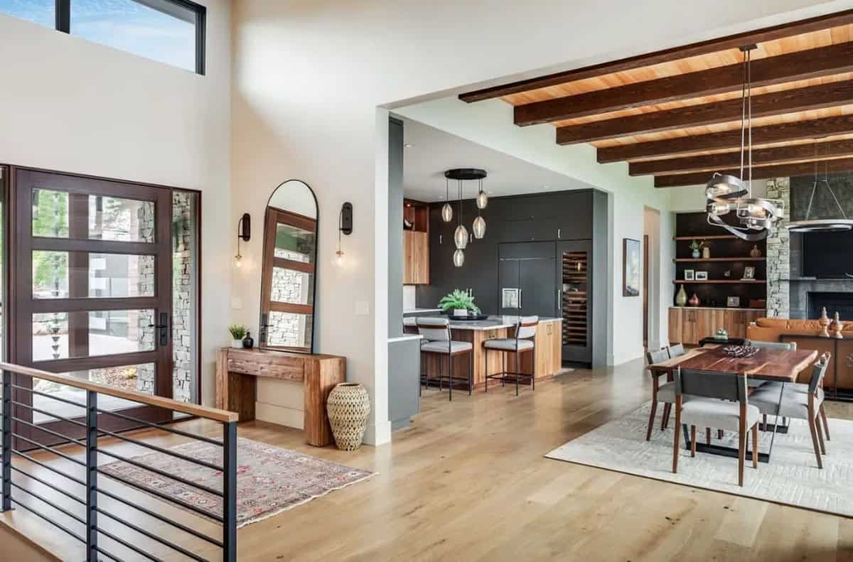 Open entry leading into kitchen and dining area with wood beams
